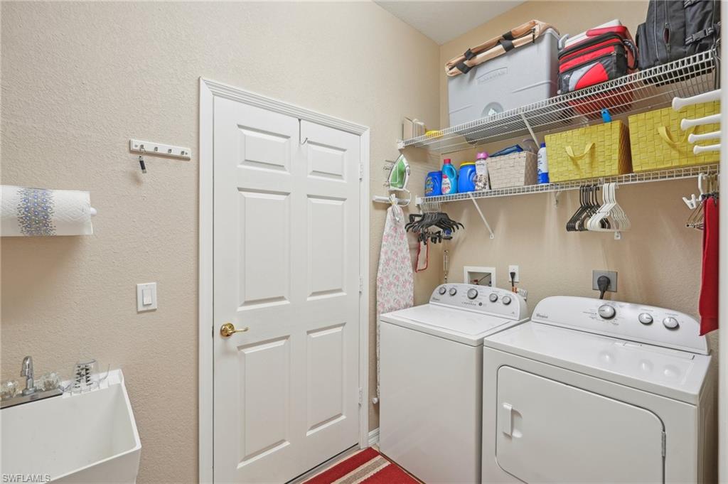 3553 Periwinkle Way Naples, FL 34114 - Photo 24 of 43 Clothes washing area with washer and clothes dryer, a sink, and laundry area