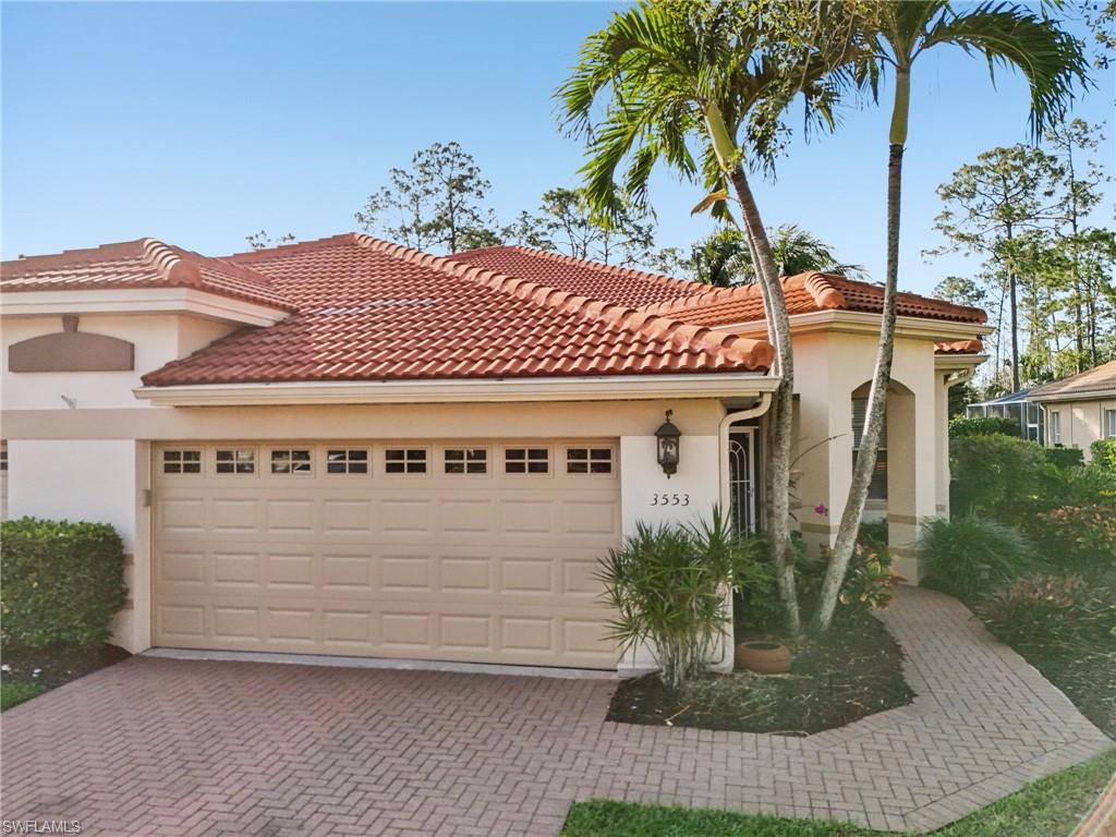3553 Periwinkle Way Naples, FL 34114 - Photo 3 of 43 Mediterranean / spanish home with a tiled roof, stucco siding, an attached garage, and decorative driveway