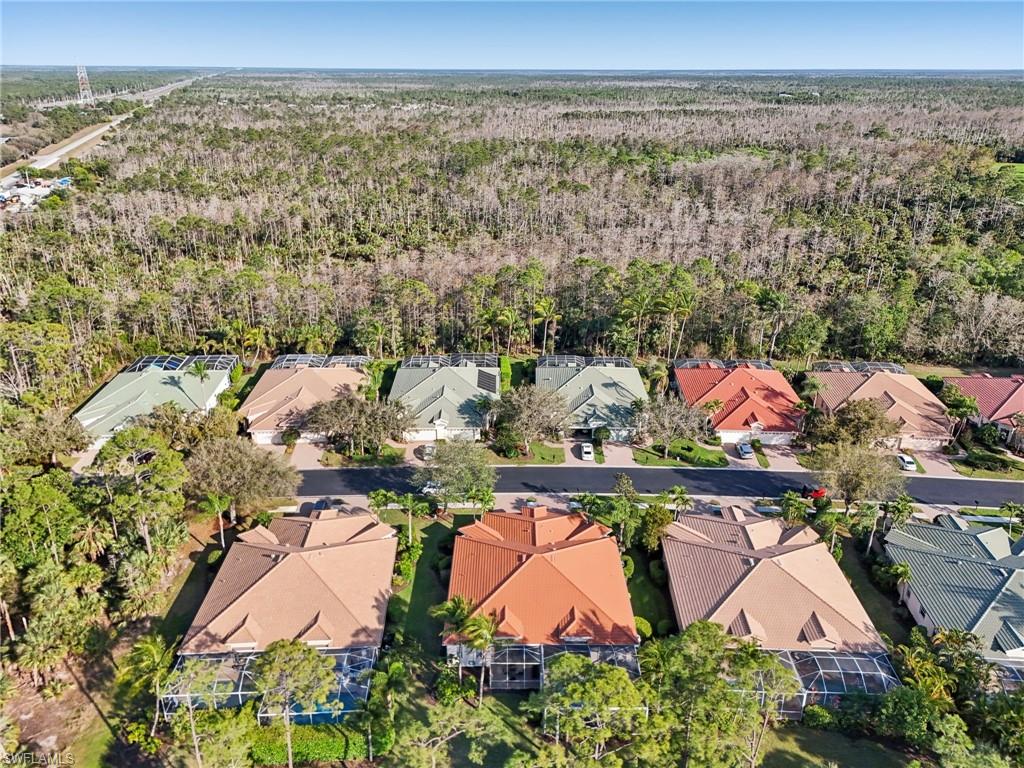 3553 Periwinkle Way Naples, FL 34114 - Photo 37 of 43 Drone / aerial view featuring a residential view and a wooded view
