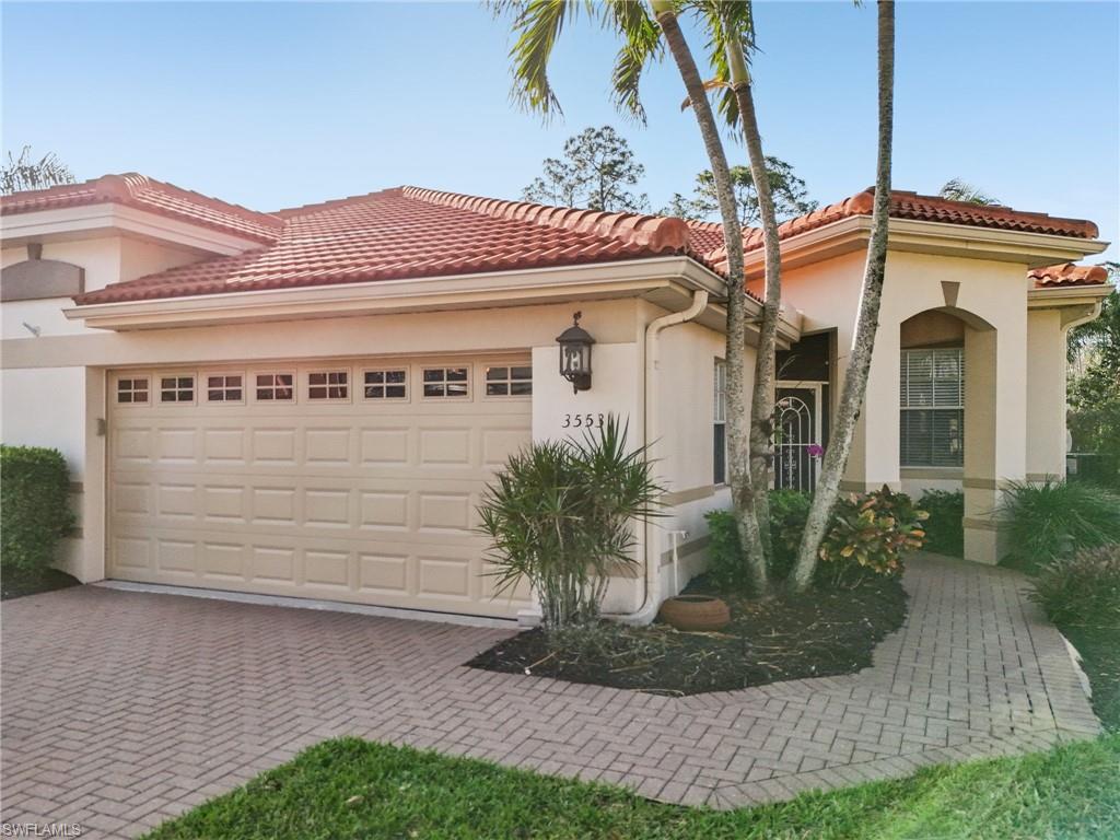 3553 Periwinkle Way Naples, FL 34114 - Photo 4 of 43 Mediterranean / spanish-style home featuring stucco siding, an attached garage, decorative driveway, and a tile roof