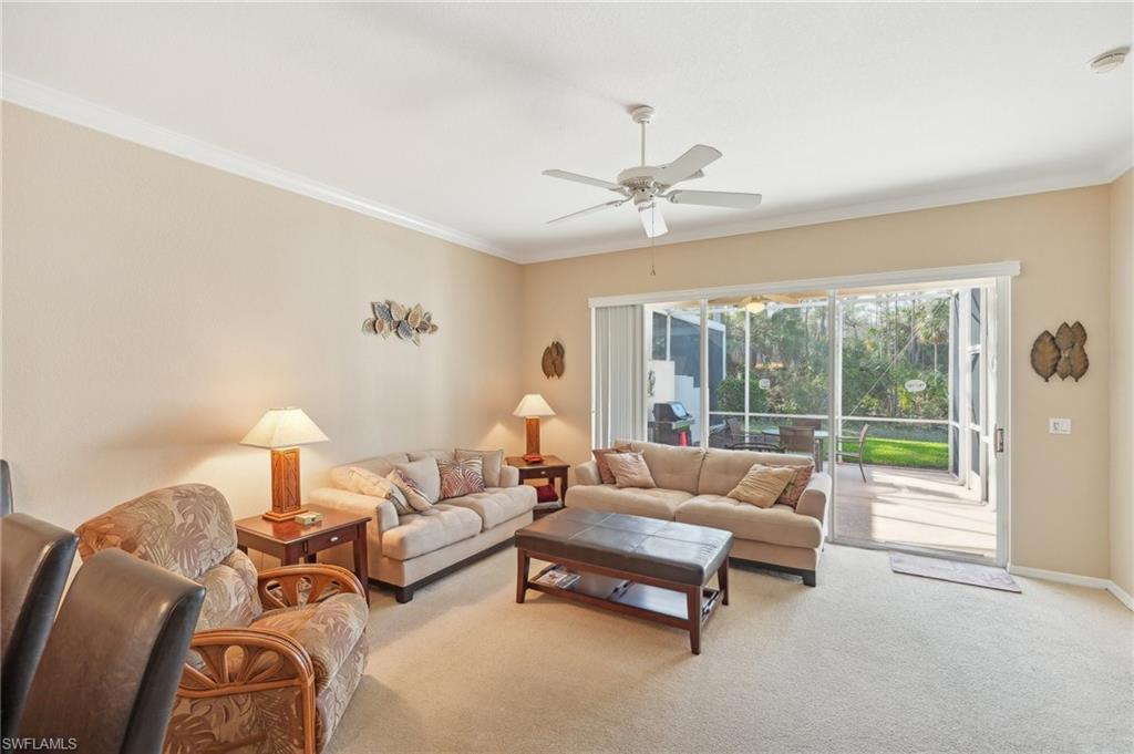 3553 Periwinkle Way Naples, FL 34114 - Photo 5 of 43 Living area featuring light colored carpet, ceiling fan, ornamental molding, and baseboards