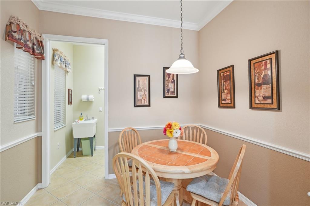3553 Periwinkle Way Naples, FL 34114 - Photo 9 of 43 Dining area featuring baseboards, light tile patterned floors, and crown molding