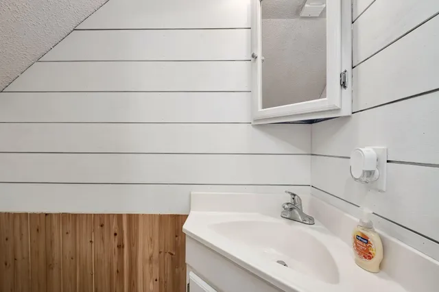 a bathroom with a sink and vanity