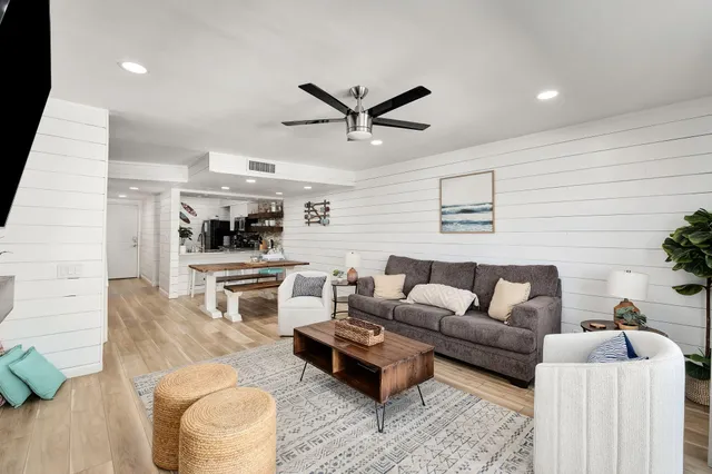 a living room with furniture and kitchen view