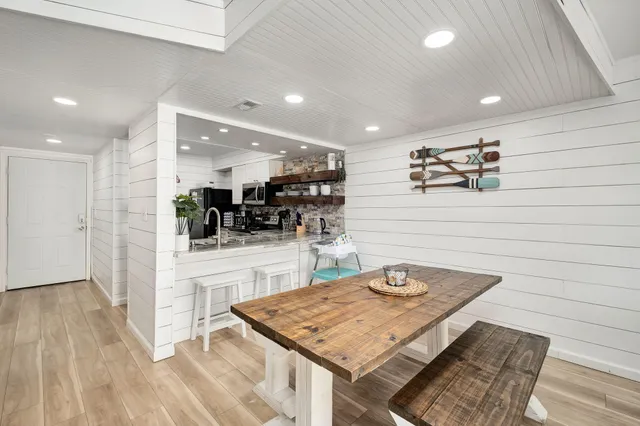 a kitchen with stainless steel appliances granite countertop a refrigerator and a stove top oven