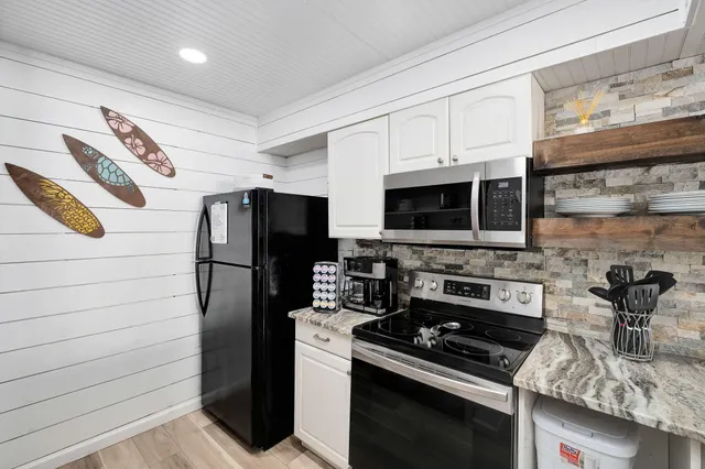 a kitchen with stainless steel appliances granite countertop a stove and a refrigerator