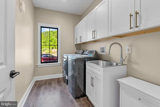 a bathroom with a granite countertop sink toilet and mirror