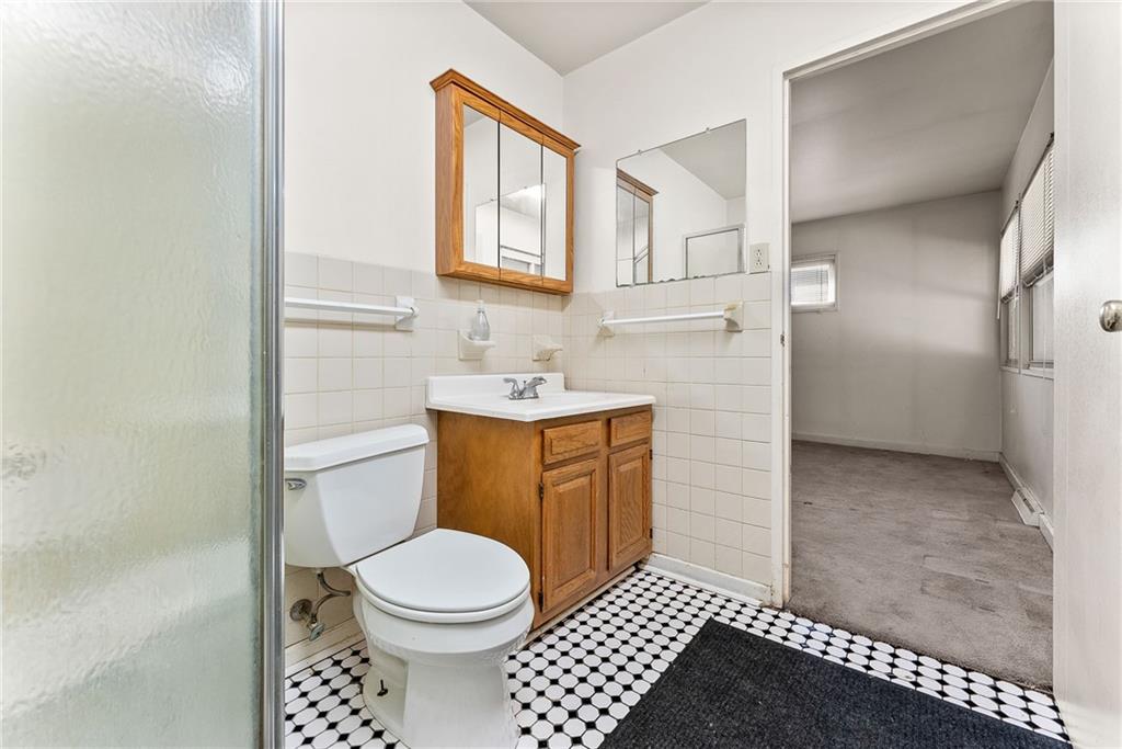 1008 Thorn Run Road Coraopolis, PA 15108 - Photo 12 of 28 a bathroom with a toilet a sink and a window