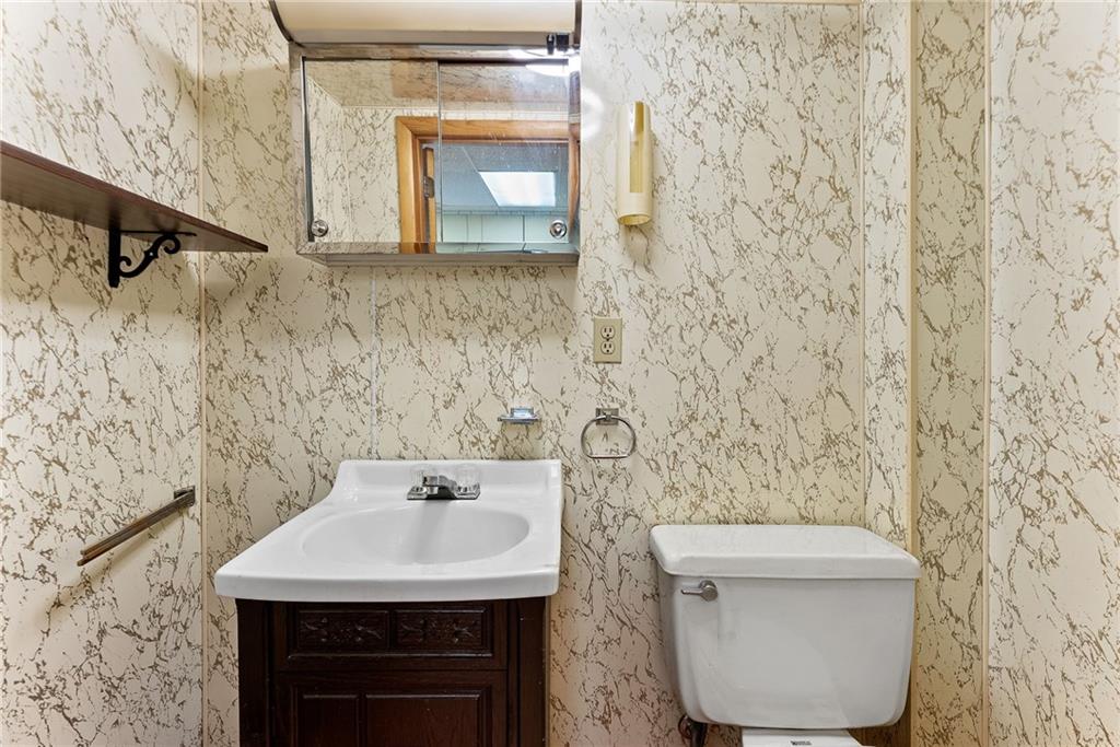 1008 Thorn Run Road Coraopolis, PA 15108 - Photo 17 of 28 a bathroom with a sink a toilet and mirror