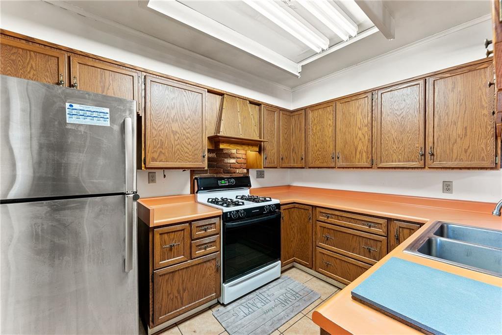 1008 Thorn Run Road Coraopolis, PA 15108 - Photo 6 of 28 a kitchen with stainless steel appliances granite countertop a refrigerator a stove and a sink