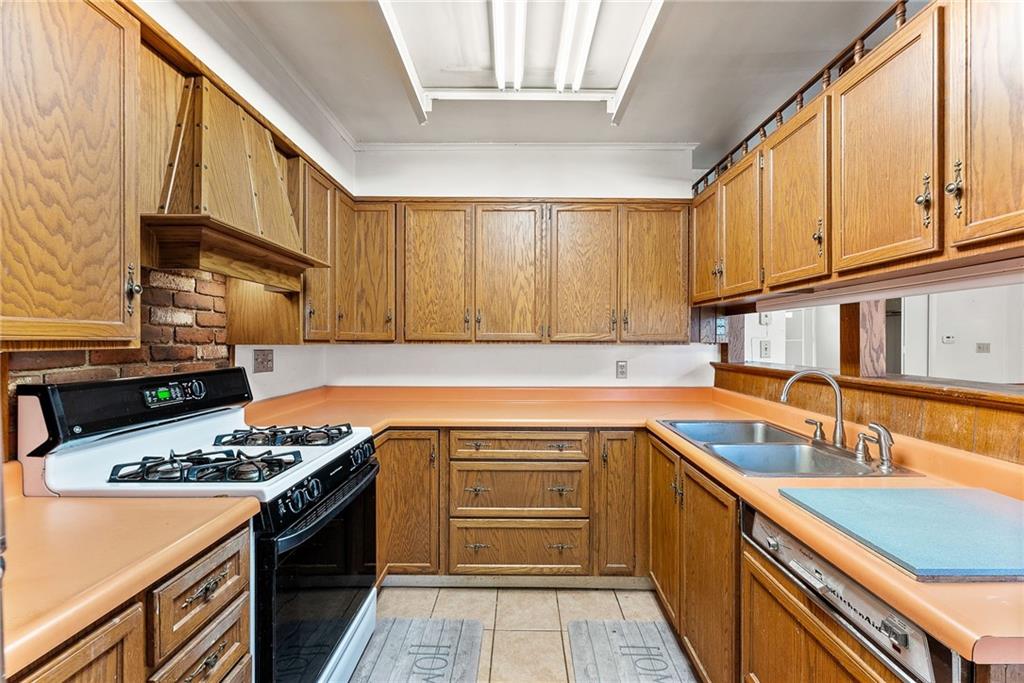 1008 Thorn Run Road Coraopolis, PA 15108 - Photo 7 of 28 a kitchen with stainless steel appliances granite countertop a stove and a sink