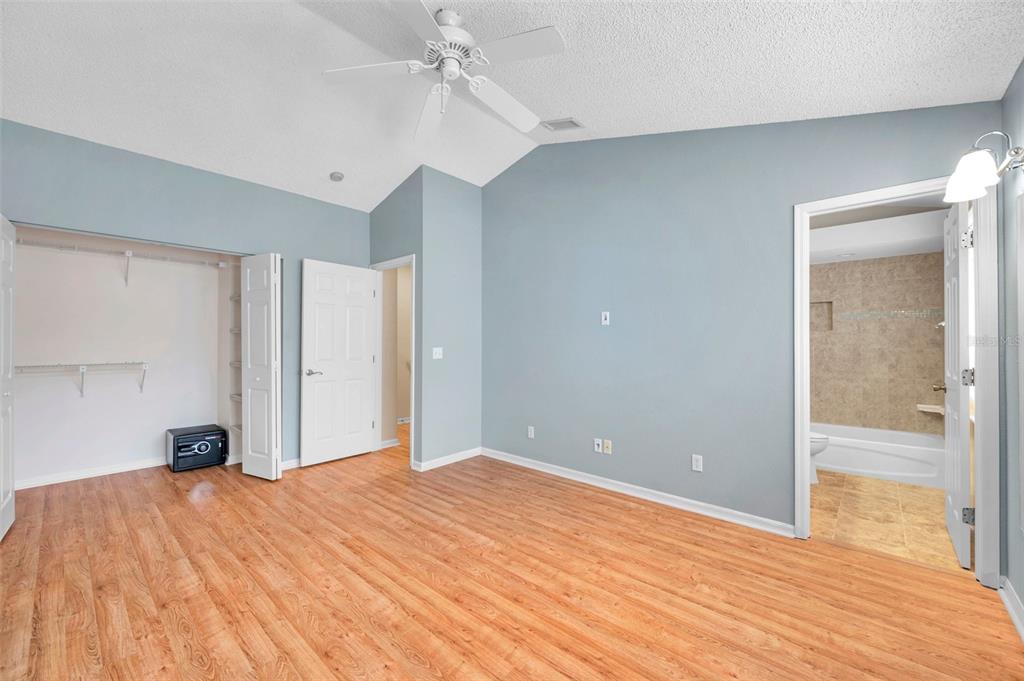 2739 Enterprise Road East, Unit 1 Clearwater, FL 33759 - Photo 12 of 20 a bedroom with a bed and a chandelier