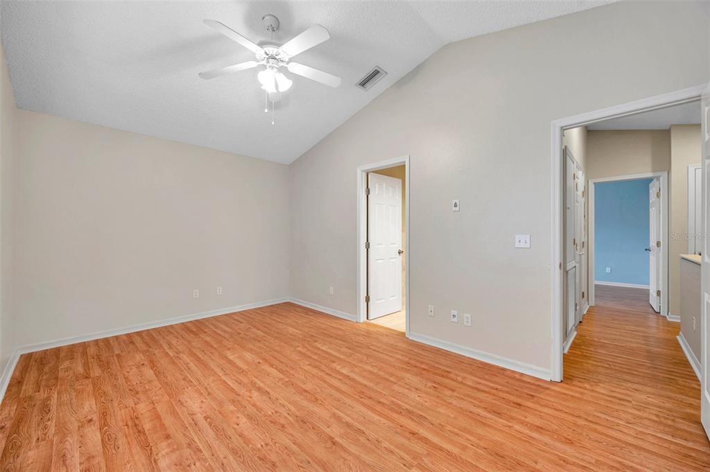 2739 Enterprise Road East, Unit 1 Clearwater, FL 33759 - Photo 13 of 20 a view of a big room with wooden floor and a chandelier fan