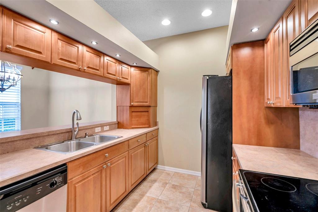2739 Enterprise Road East, Unit 1 Clearwater, FL 33759 - Photo 9 of 20 a kitchen with stainless steel appliances a sink stove and refrigerator