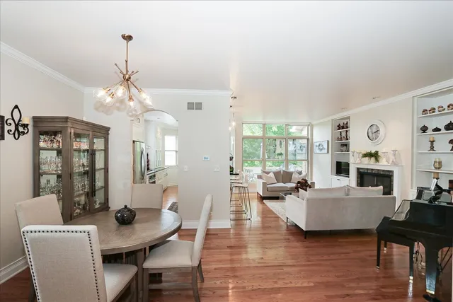 a living room with fireplace furniture and a chandelier