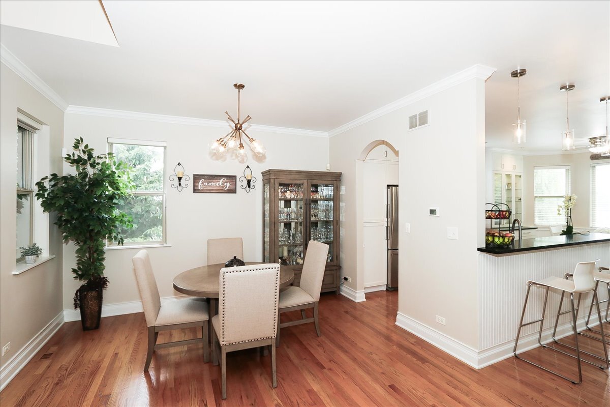 768 St Johns Place Addison, IL 60101 - Photo 13 of 39 a view of a dining room with furniture and wooden floor