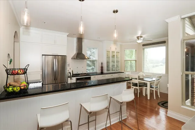 a kitchen with stainless steel appliances granite countertop sink stove top oven and cabinets