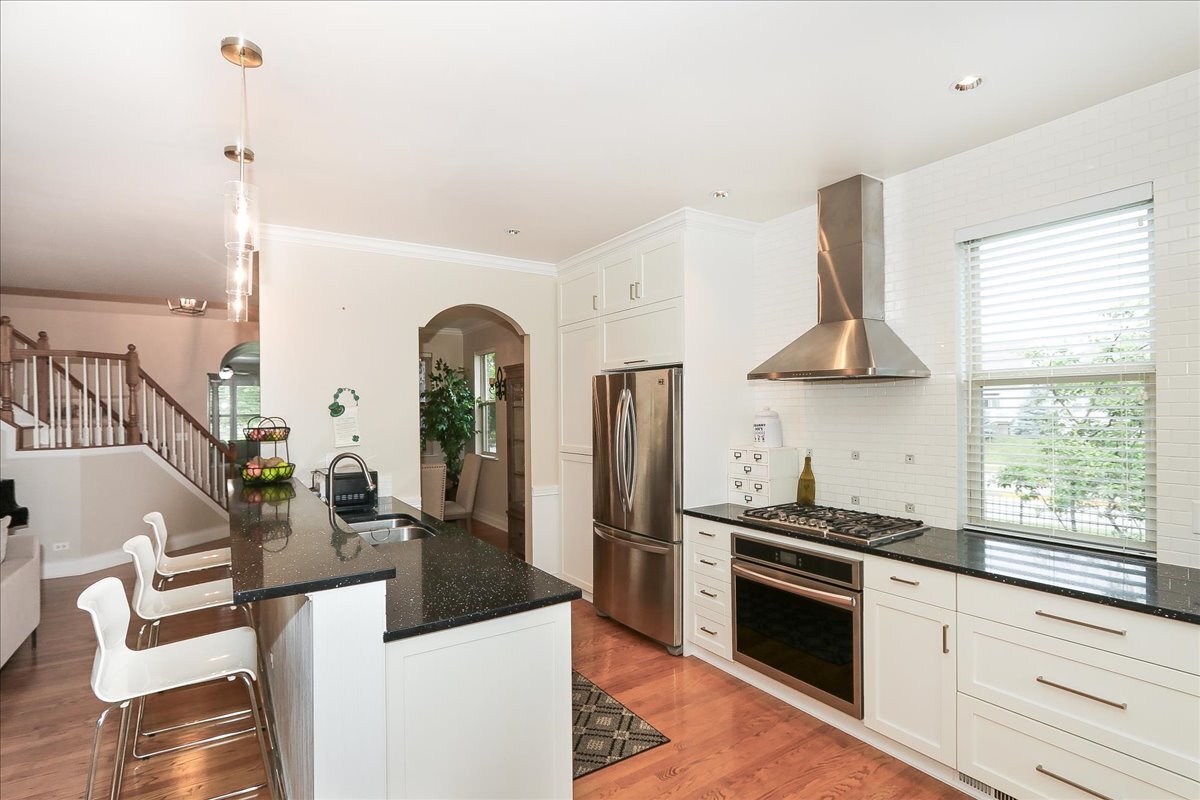 768 St Johns Place Addison, IL 60101 - Photo 16 of 39 a kitchen with stainless steel appliances granite countertop a stove a sink and a refrigerator