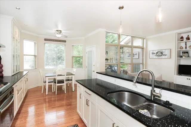 a kitchen with granite countertop a sink and a counter top space