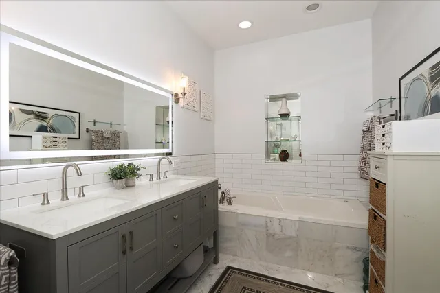 a bathroom with a sink a mirror and a bathtub