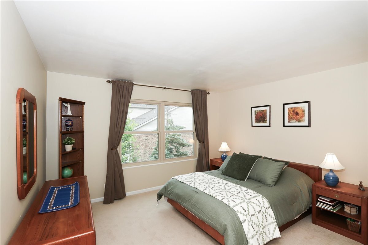 768 St Johns Place Addison, IL 60101 - Photo 28 of 39 a bedroom with a bed and a large window