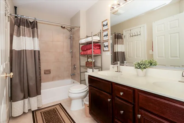 a bathroom with a sink a toilet a tub and shower