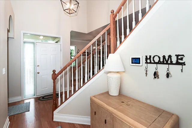 a view of entryway and hall with wooden floor