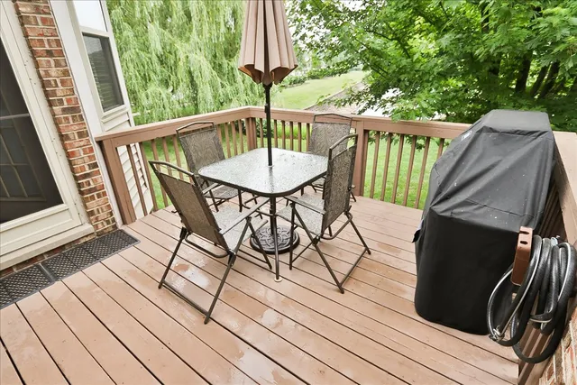 a view of balcony with wooden floor and outdoor seating