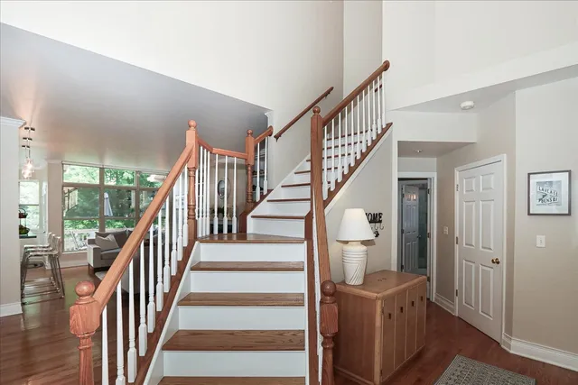 a view of entryway and hall with wooden floor