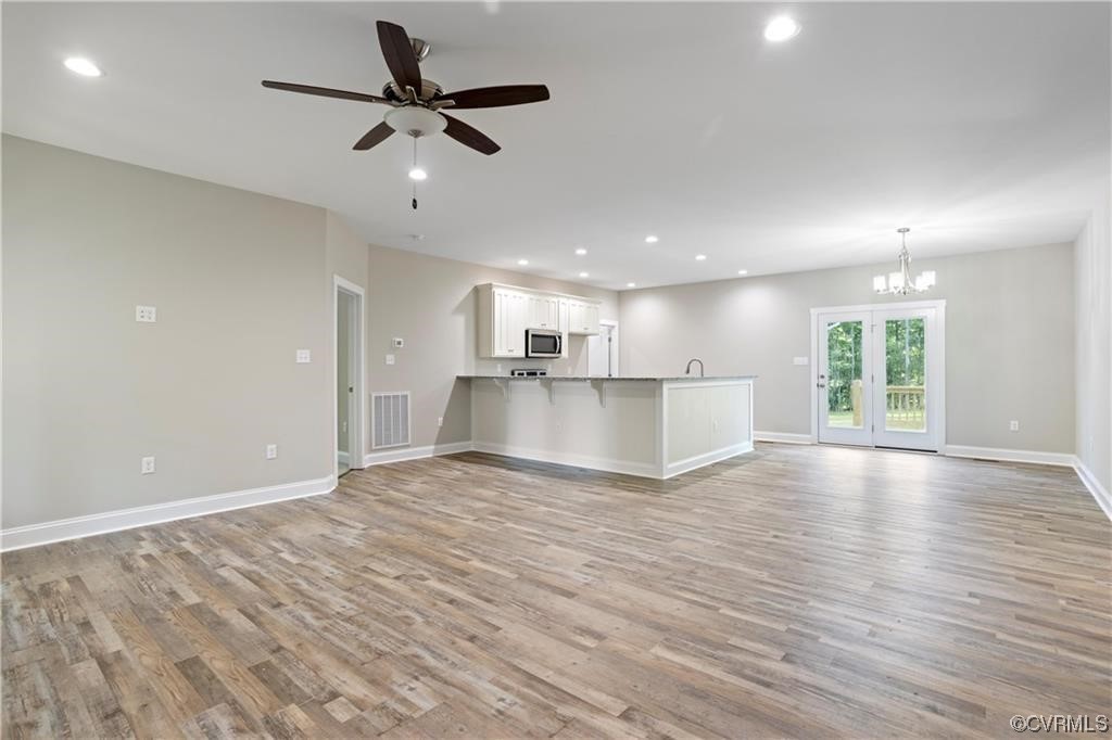3734 Fredericks Hall Road Mineral, VA 23117 - Photo 3 of 9 a view of an empty room with wooden floor and a window