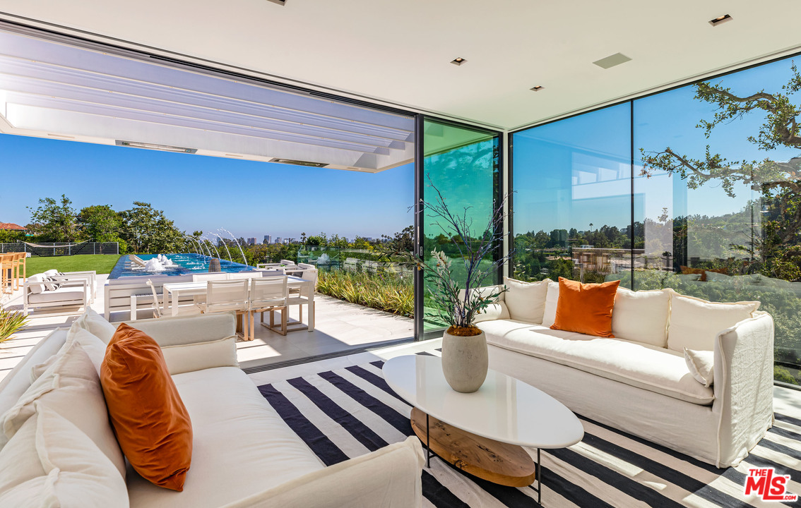1259 Beverly Estate Drive Beverly Hills, CA 90210 - Photo 11 of 43 a living room with patio furniture and a floor to ceiling window