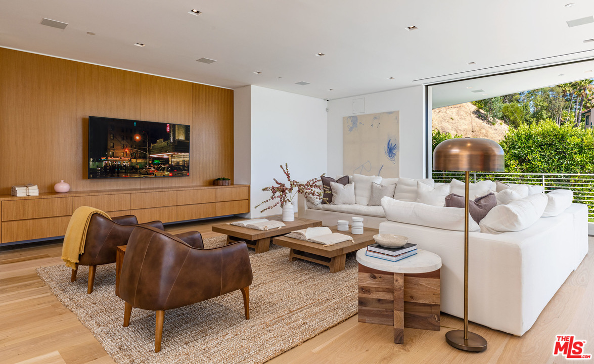 1259 Beverly Estate Drive Beverly Hills, CA 90210 - Photo 15 of 43 a living room with furniture and a flat screen tv