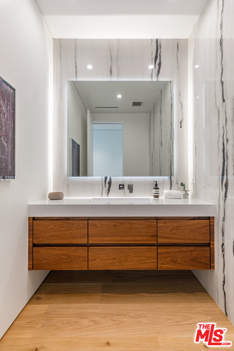 1259 Beverly Estate Drive Beverly Hills, CA 90210 - Photo 17 of 43 a bathroom with a sink and a mirror