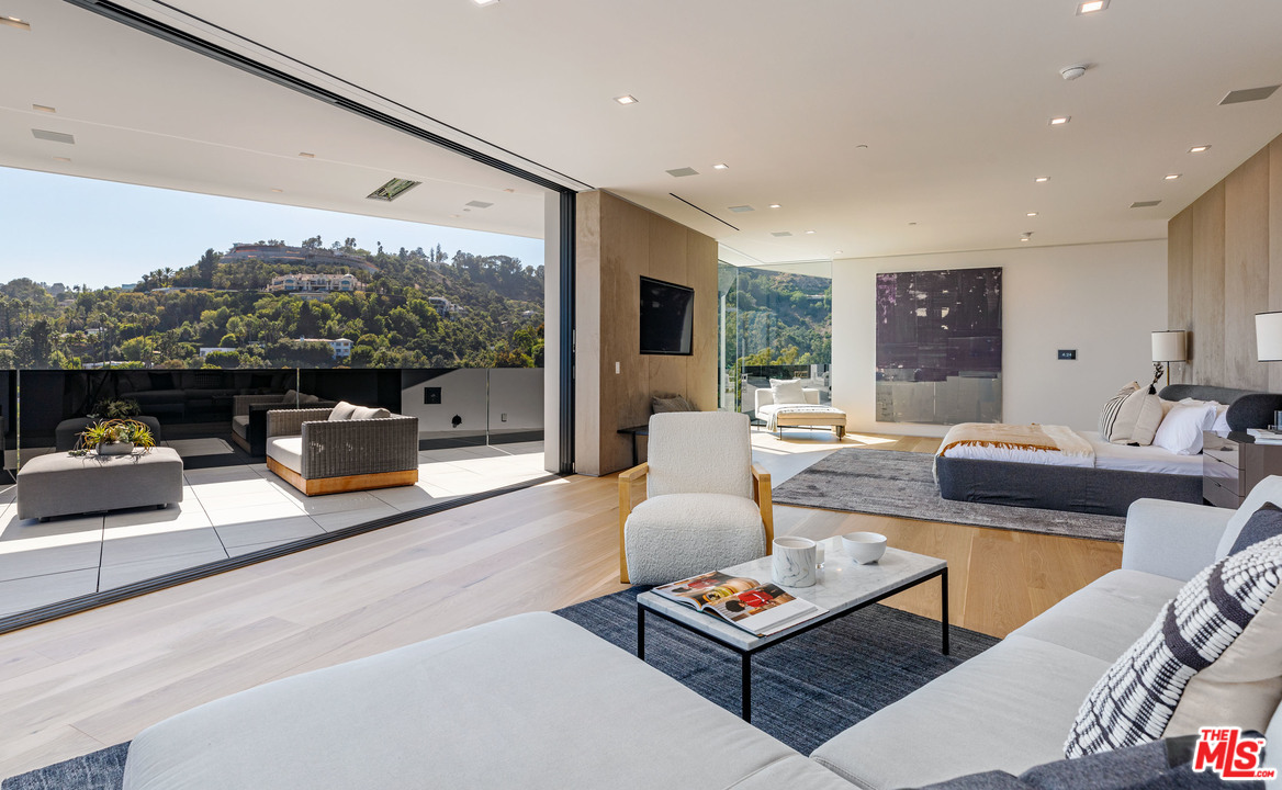 1259 Beverly Estate Drive Beverly Hills, CA 90210 - Photo 21 of 43 a living room with furniture fireplace and a large window
