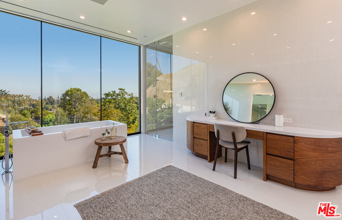 1259 Beverly Estate Drive Beverly Hills, CA 90210 - Photo 23 of 43 a living room with furniture a mirror and a large window