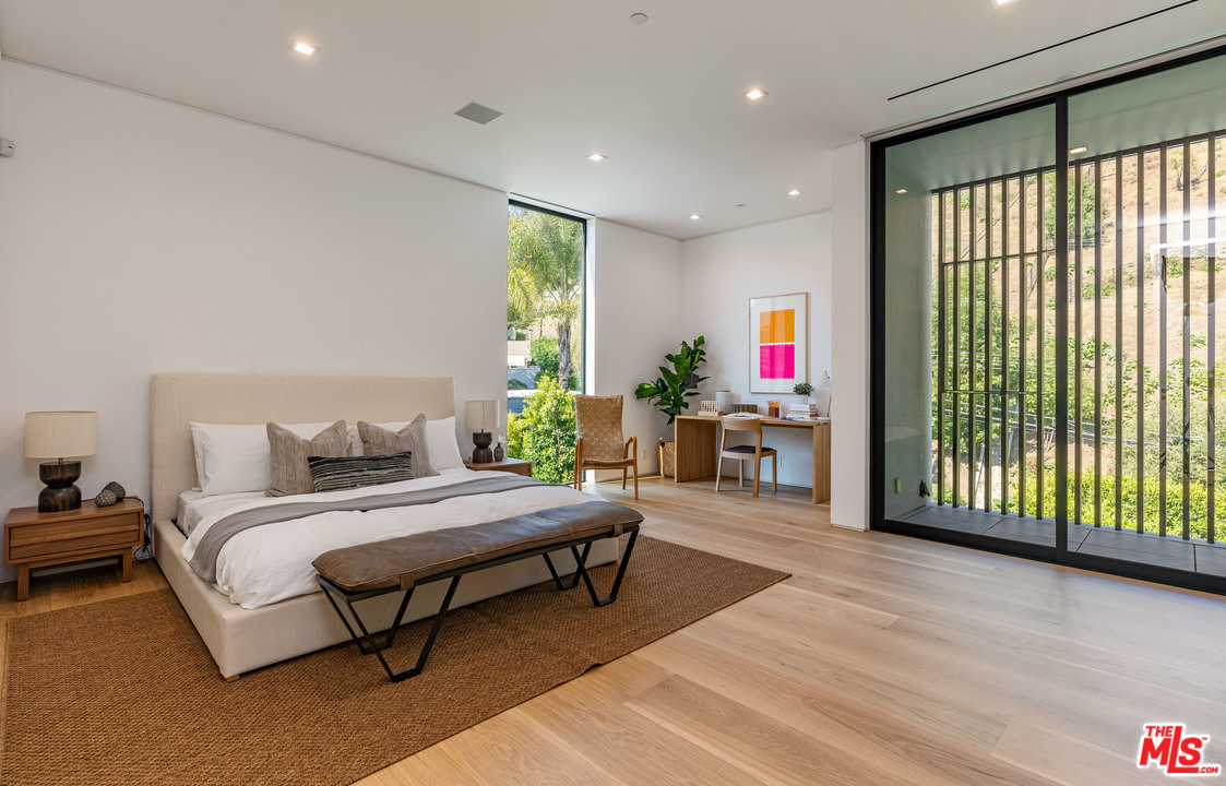 1259 Beverly Estate Drive Beverly Hills, CA 90210 - Photo 27 of 43 a bedroom with a bed and a large window