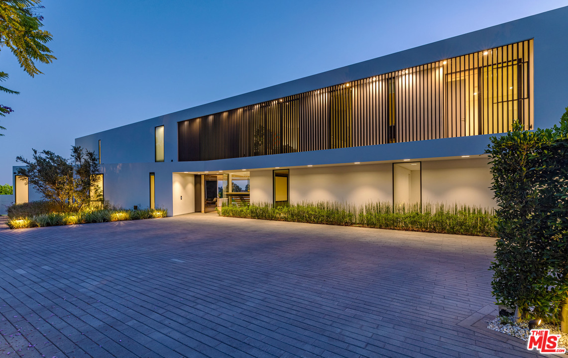 1259 Beverly Estate Drive Beverly Hills, CA 90210 - Photo 31 of 43 a view of a house with a yard and a garage