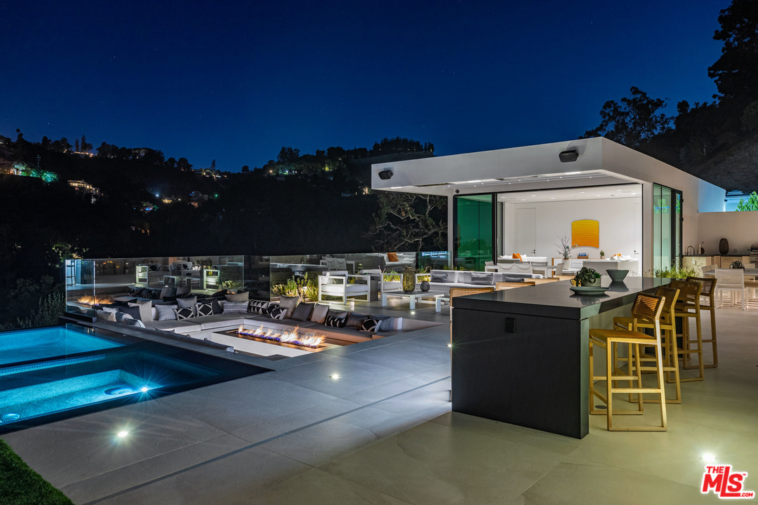 1259 Beverly Estate Drive Beverly Hills, CA 90210 - Photo 37 of 43 a view of a patio with dining table and chairs with plants