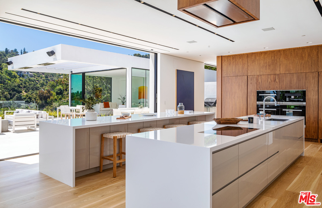 1259 Beverly Estate Drive Beverly Hills, CA 90210 - Photo 8 of 43 a kitchen with stainless steel appliances granite countertop a sink and cabinets
