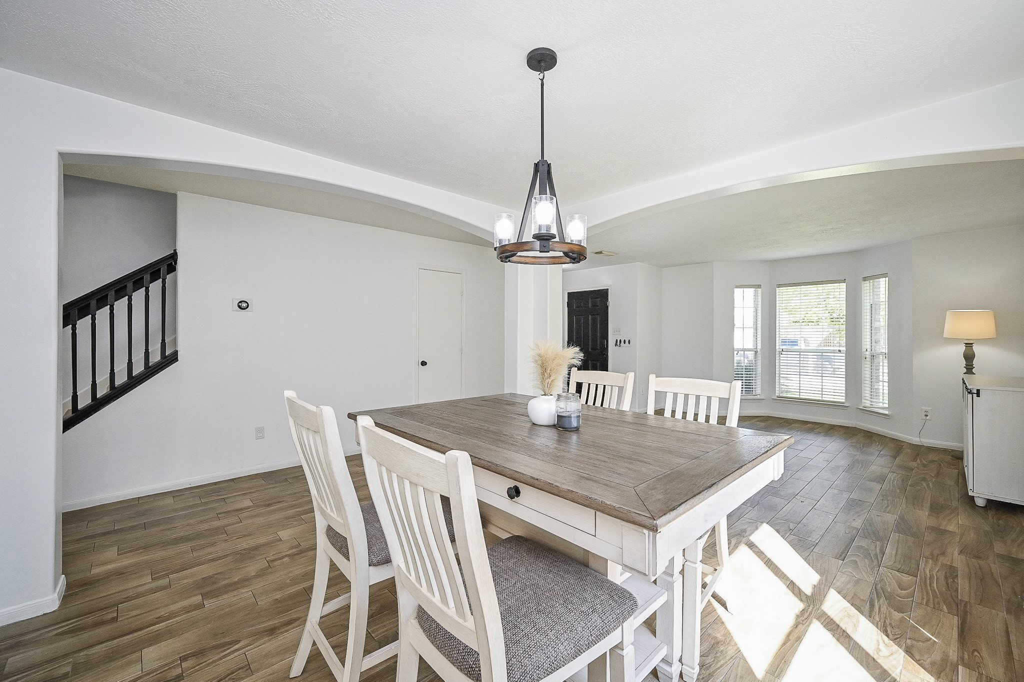2534 Halstead Drive Spring, TX 77386 - Photo 12 of 35 Bright and inviting this formal dining area features wood look tile flooring, and a modern chandelier. The open ayout leads to a cozy formal living space that can also be used as a study. You will love the large windows for ample natural light.