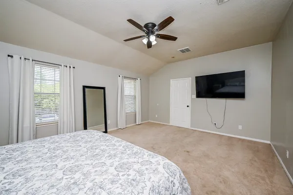 a bedroom with a large bed and window