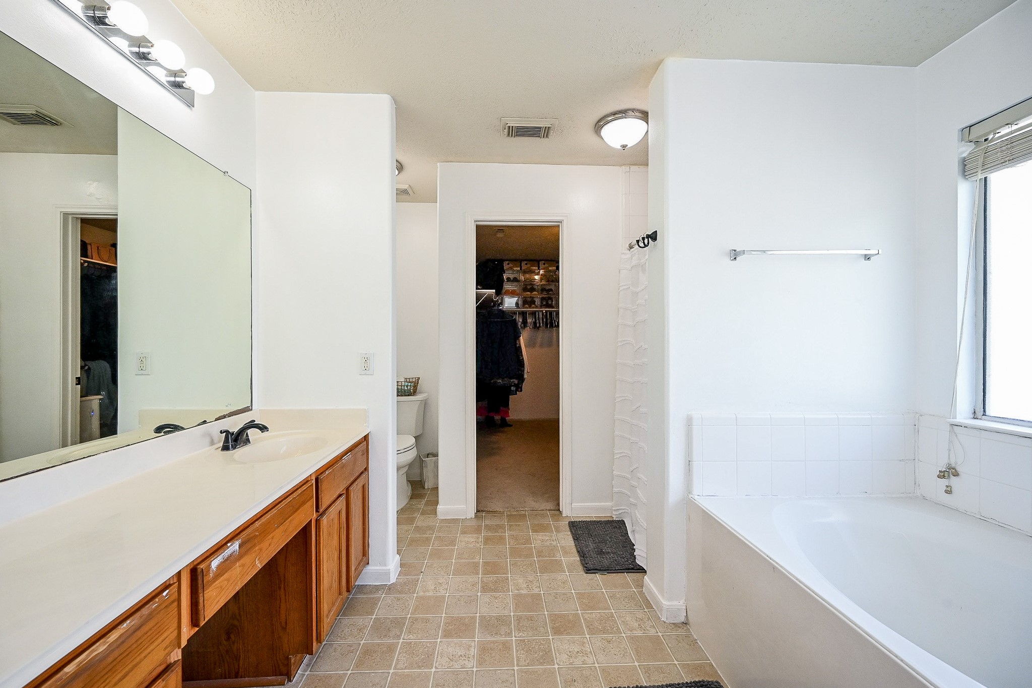 2534 Halstead Drive Spring, TX 77386 - Photo 27 of 35 The primary bathroom is just off of the primary room. It features a large walk in closet and separate soaking tub and shower.