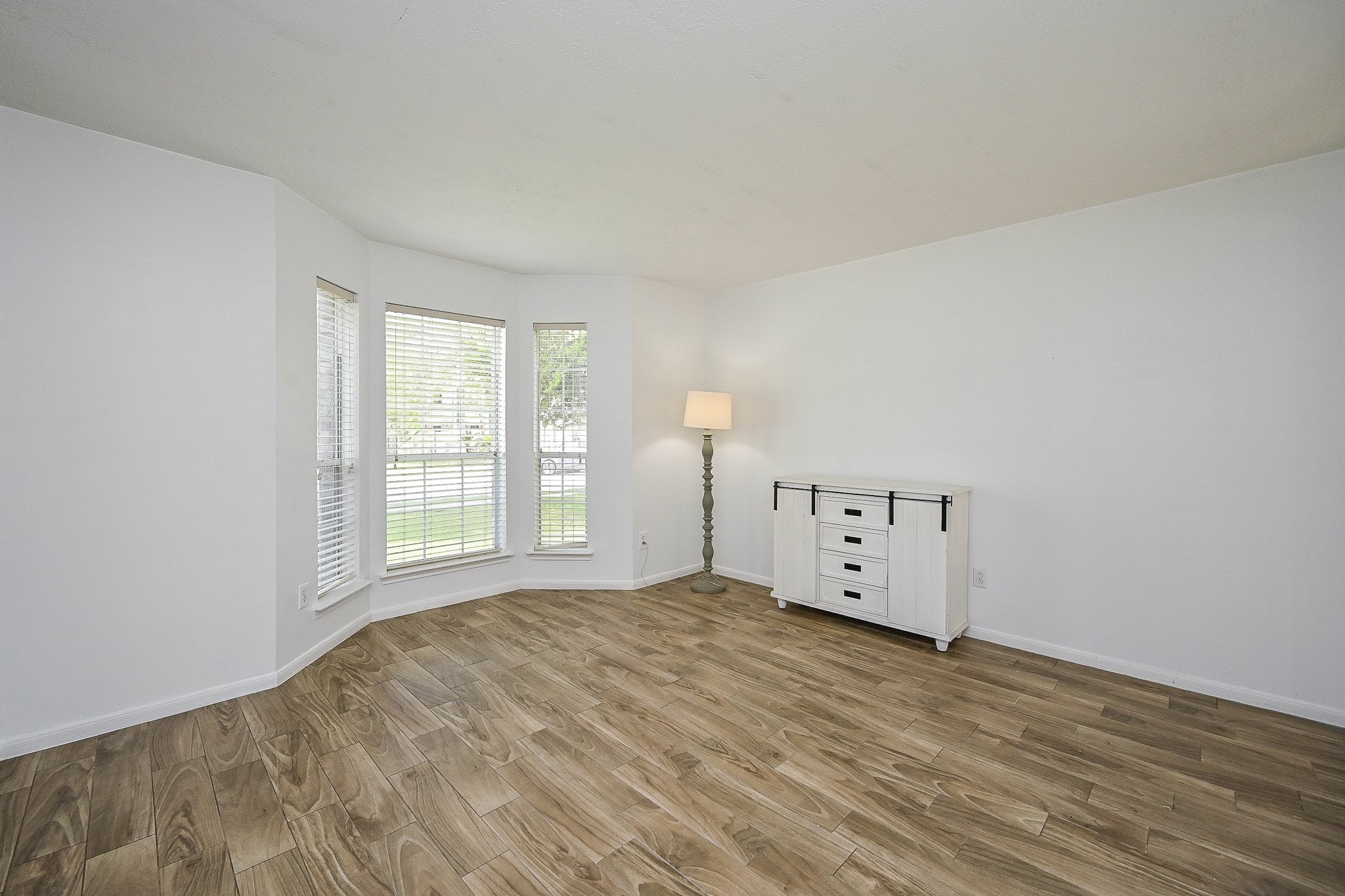 2534 Halstead Drive Spring, TX 77386 - Photo 9 of 35 This room features light wood flooring, large bay windows for natural light, and a neutral color scheme, creating a bright and inviting space.