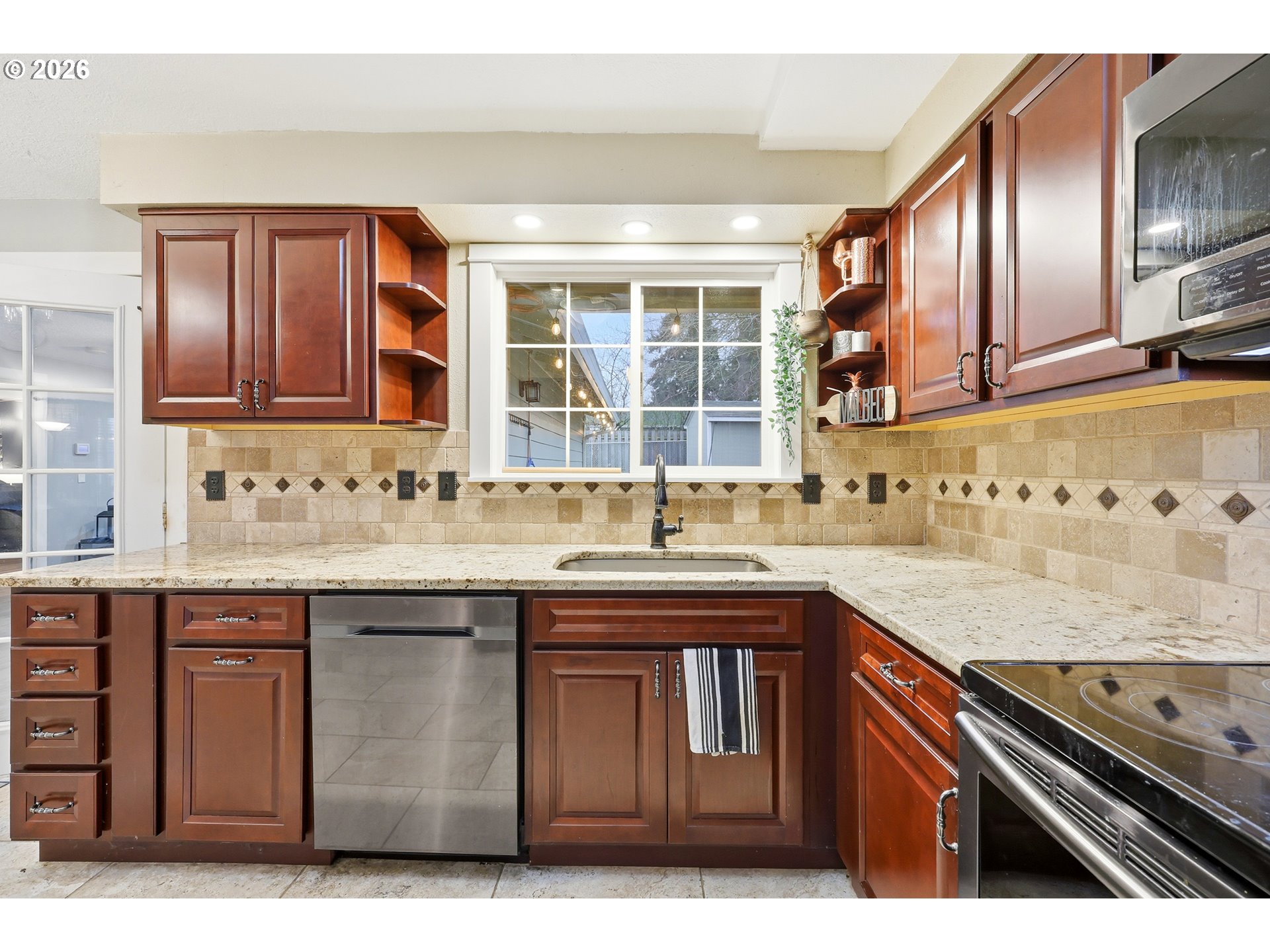 2073 Southeast Kane Avenue Gresham, OR 97080 - Photo 9 of 25 a kitchen with stainless steel appliances granite countertop a sink stove and cabinets