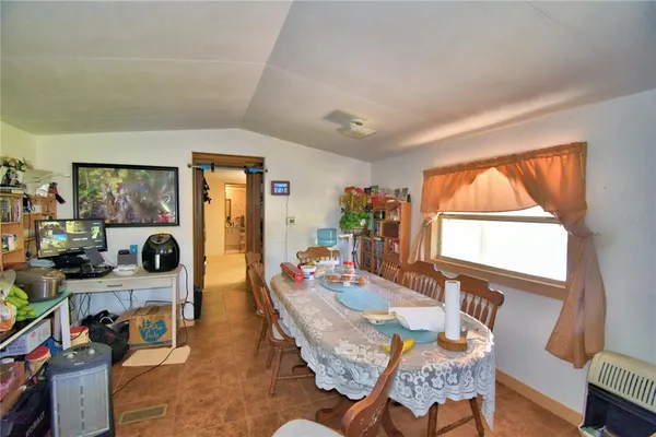 a backyard of a house with table and chairs