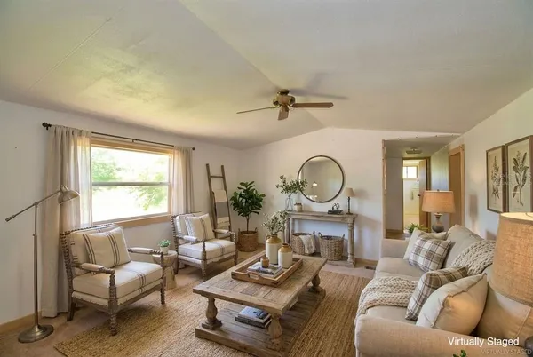 a living room with furniture and a large window