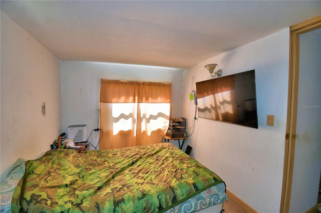 2039 Ranchland Drive Lakeland, FL 33809 - Photo 30 of 93 a bed sitting in a bedroom next to a window