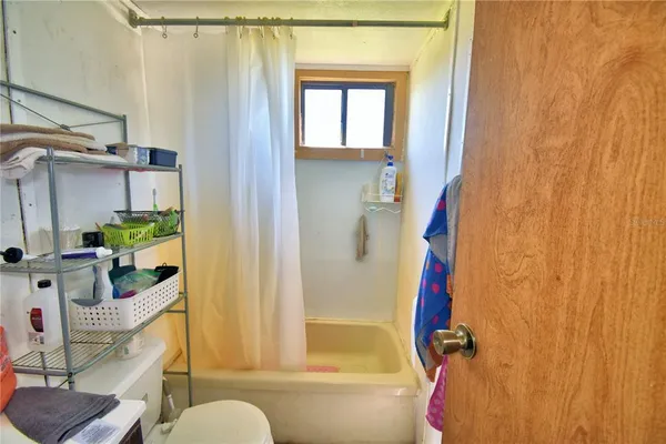 a green field with trees in the background