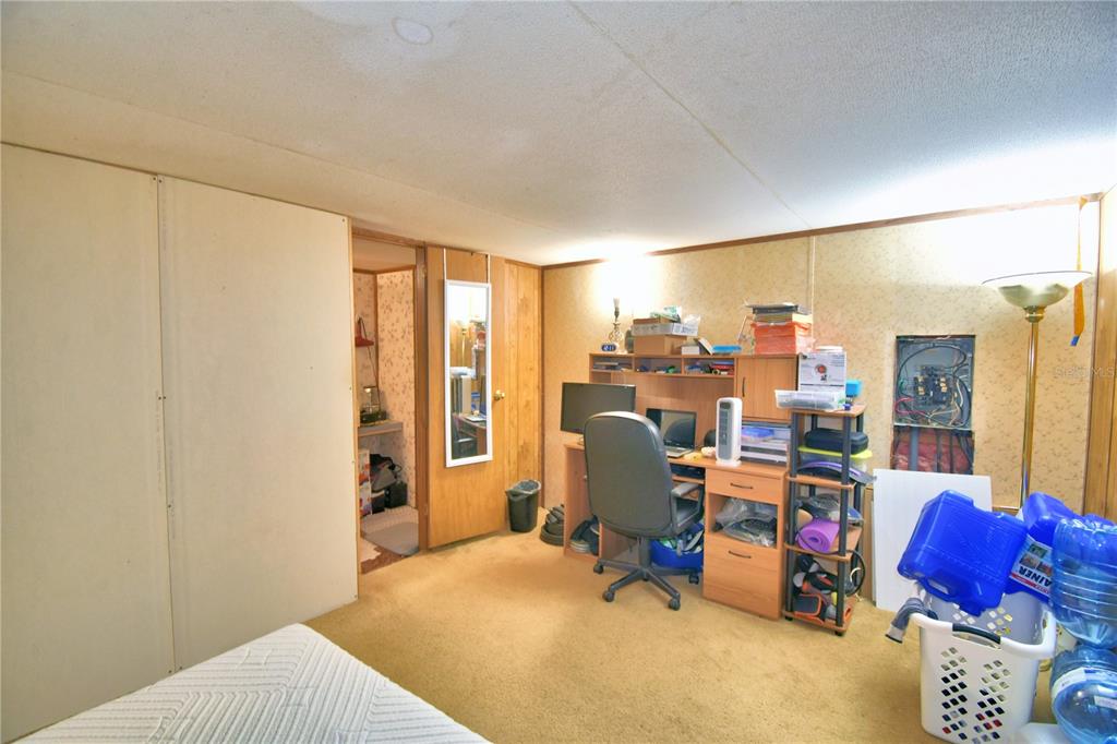 2039 Ranchland Drive Lakeland, FL 33809 - Photo 33 of 93 a bed room with a bed and a chair