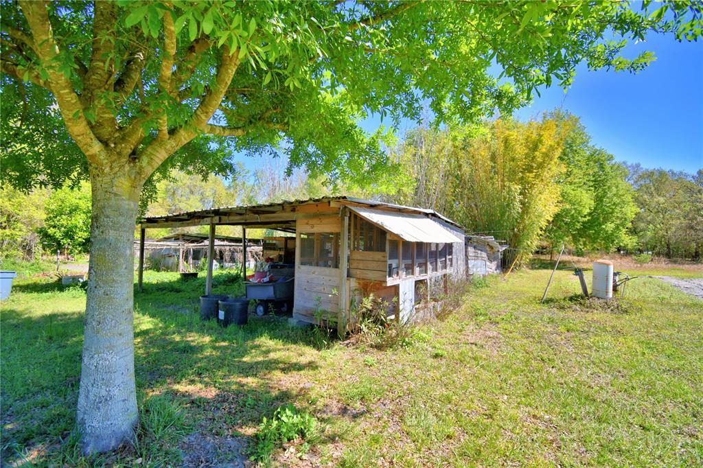 2039 Ranchland Drive Lakeland, FL 33809 - Photo 52 of 93 a backyard of a house with table and chairs
